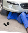 Mechanic installing Spare Tire Bolt Replacement for Car and RV, durable plastic hold down screw visible on the floor.