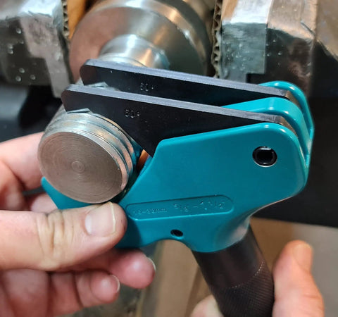 Close-up of Universal Thread Repair Tool And Restorer For All Threads In Range Five Eighths Inch To One And A Half Inches External Or Internal Threads Metric And SAE One Hand Tool Quick Sizing Chases And Repairs Threads in use on metal thread