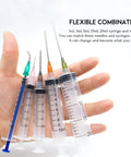 Hand holding Pro Grade Glue Applicator Syringe Set With Blunt Tip Needles And Caps For Liquid Glue Ink Perfume Lip Gloss Making