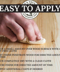 Applying Danish Oil Wood Finish For Furniture And Rustic Pieces with a cloth on wood surface, food safe, deep penetration.