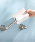 Banbury Pivoting Toilet Paper Holder in Brushed Nickel, showing hand mounting toilet paper, zinc construction, spring-free design