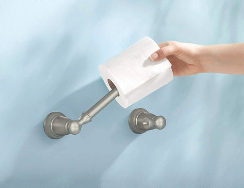 Banbury Pivoting Toilet Paper Holder in Brushed Nickel, showing hand mounting toilet paper, zinc construction, spring-free design
