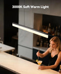 LED Linear Pendant Light 25W Black Hanging Bar Fixture illuminating a bar area with 3000K warm white light.
