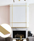 Kick Up Your Rooms With Matte Gold Peel And Stick Molding Trim on modern white wall with fireplace, shown in close-up detail.