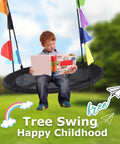 Child reading on 40 Inch Saucer Tree Swing For Kids With Heavy Duty Steel Frame Foam Padding Braided Ropes Secure Metal Rings