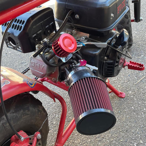 Close-up of a mounted two pack 12mm universal red cone air filter for car and motorcycle cold air intake upgrade on a bike.