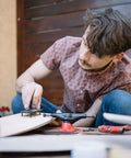 Person assembling longboard using Black 1.25 Inch Longboard Hardware Screws And Nuts Set for Skateboards and Cruisers