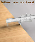 Heavy Duty 8 Inch Stainless Steel Scriber Caliper With Raw Hardened Carbide Scribe Needles marking a line on wood surface.