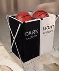 Two Section Laundry Basket With Foldable Design holding basketballs, featuring black and white sections and aluminum frame.