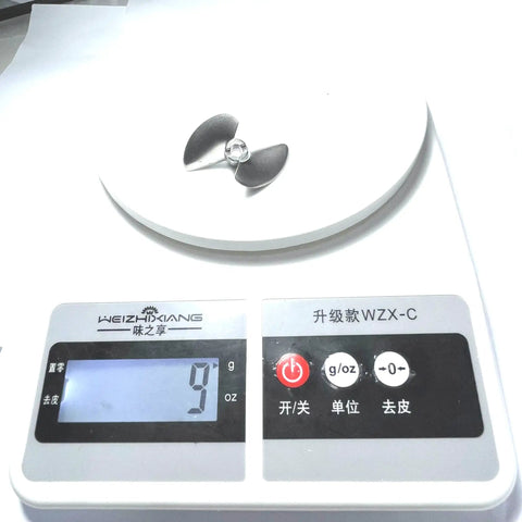 Beefed-Up 4mm Metal Propeller Upgrade For UDI Arrow RC Boats on digital scale showing weight