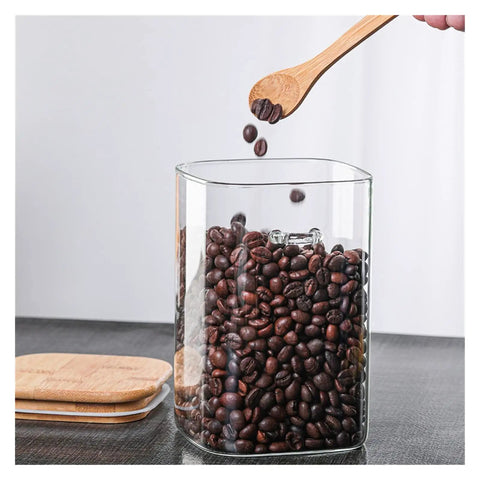 Hella Airtight Hand Blown Glass Coffee Canister With Spoon for Top Shelf Kitchen Organization filled with coffee beans.