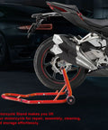 Beast Tough Motorcycle Lift Stand For Sport Bikes Front And Rear Wheel Lift Adjustable Steel Stand Up To 850 Lbs For Easy Maintenance And Repairs Fits Yamaha Kawasaki Honda Suzuki Red in use on a sport bike rear wheel in a garage setting.