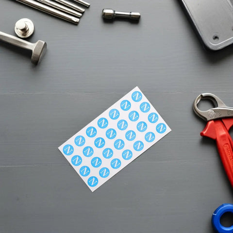 Ground Wire ID Labels 200pc Set For Electrical Boxes And Control Panels, PVC Stickers With International Standards, Universal Indoor And Factory Use, Earth Ground, Neutral, Phase Tags sheet on gray workbench