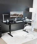 Vivo Black Height Adjustable Standing Desk 71x30 Inch Electric Sit Stand Workstation with monitor and ergonomic chair.