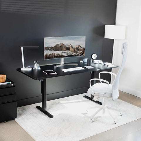 Vivo Black Height Adjustable Standing Desk 71x30 Inch Electric Sit Stand Workstation with monitor and ergonomic chair.