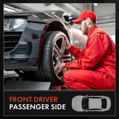 Mechanic inspecting front driver passenger side wheel of a car on a lift in a garage setting.