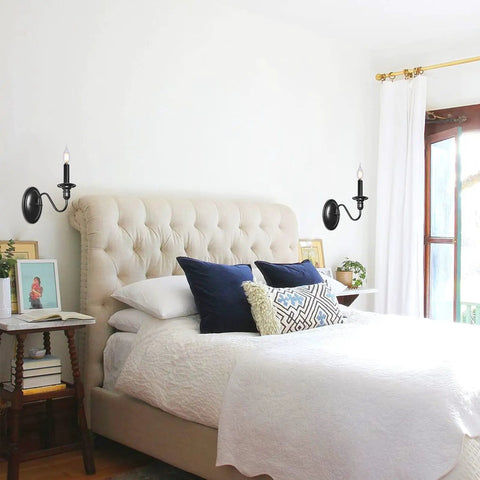 Black Wall Sconces Set Of Two Modern Farmhouse Candle Wall Lamps beside bed with tufted headboard in bright bedroom