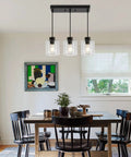 Sleek Black Three Light Pendant Fixtures Hit Different In Modern Kitchen Islands Or Dining Rooms Adjustable Clear Glass Shade Lamps With Killer Style above a dining table.