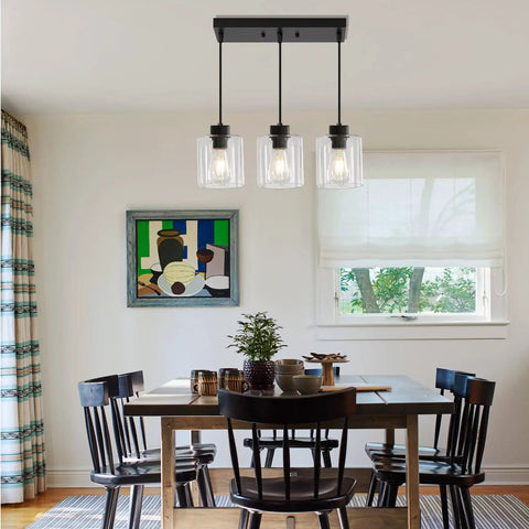 Sleek Black Three Light Pendant Fixtures Hit Different In Modern Kitchen Islands Or Dining Rooms Adjustable Clear Glass Shade Lamps With Killer Style above a dining table.