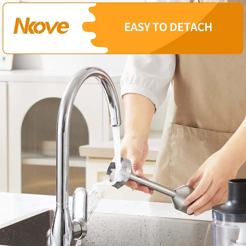 Workhorse 800 Watt Corded Handheld Stick Blender being rinsed under faucet in kitchen; stainless steel construction, easy to detach.