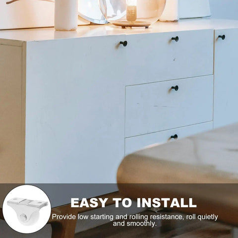 Image showing a 12pcs Inch White PP Directional Caster Wheel for Furniture DIY mounted on a modern white cabinet.