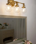 Three Light Vintage Industrial Bathroom Vanity Wall Sconce With Handblown Clear Glass Globes And Antique Gold Finish, 25.2 Inch Wide Triple Light Bath Fixture