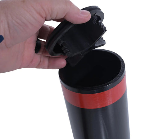 Hand holding cap for Badass 24 Inch Steel Garage Safety Bollard Wall Defender Pipe Guard with Matte Black Finish.