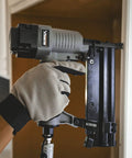 Hand using 2 In 1 18 Gauge Pneumatic Brad Nailer And Narrow Crown Stapler for trim work
