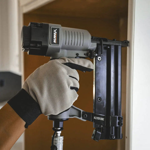 Hand using 2 In 1 18 Gauge Pneumatic Brad Nailer And Narrow Crown Stapler for trim work