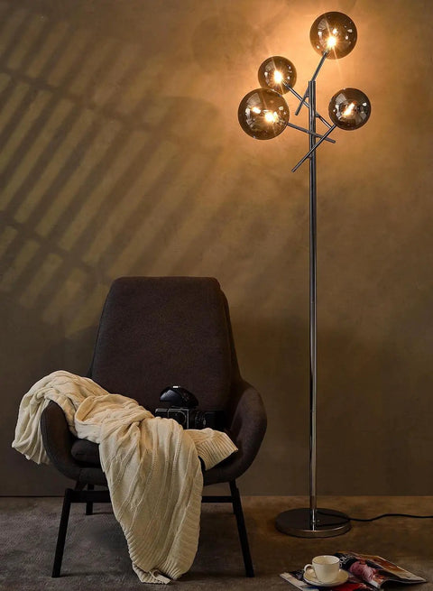 Sputnik 4 Light Floor Lamp With Smoky Grey Glass Globes, Chrome Finish in modern living room with cozy armchair