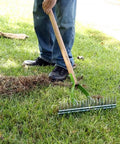 Person using 15 Inch Adjustable Self Cleaning Thatch Rake With Hardwood Handle For Lawn Care Curved Tines For Clearing Dead Grass Clippings