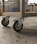 Heavy Duty Swivel Plate Caster Wheel With Standard Mount Bracket For Rough Terrain Replacement On Industrial Carts And Dollies Single Pack visible on a cart gliding over rough terrain with rubble.