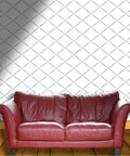 Go Ahead Upgrade Your Space With This Solid Light Neutral Textured Wallpaper Roll Featuring Thick Durable Vinyl Peel And Stick Design That Lets You Make Walls Pop Without Any Hassle, showcased behind a red leather couch.