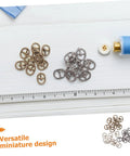 Mini Alloy Belt Buckles Set For Doll Clothes And Tiny Belts, 150 Pcs Small Single Prong Fasteners In Silver Gunmetal And Antique Bronze, DIY Crafting Sewing Accessories For Miniature Projects And Doll Fashion Fans displayed on a table with ruler and sewing supplies