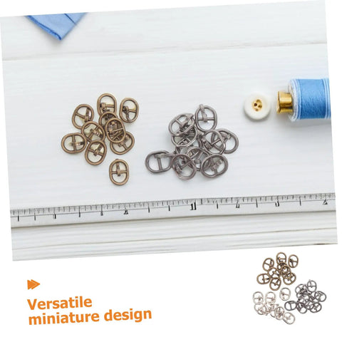 Mini Alloy Belt Buckles Set For Doll Clothes And Tiny Belts, 150 Pcs Small Single Prong Fasteners In Silver Gunmetal And Antique Bronze, DIY Crafting Sewing Accessories For Miniature Projects And Doll Fashion Fans displayed on a table with ruler and sewing supplies
