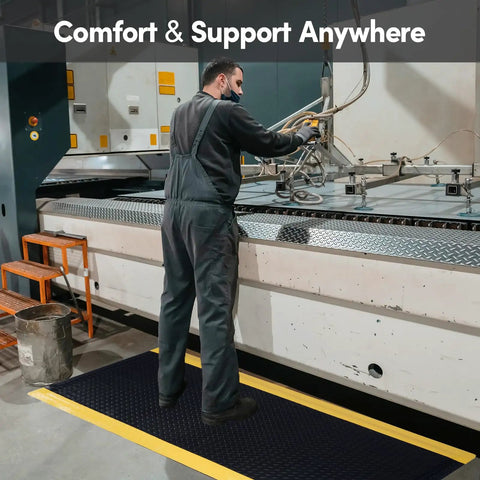 Worker using machine while standing on Heavy Duty Anti Fatigue Mat 3 Ft By 6 Ft Diamond Plate Ergonomic Standing Floor Mat