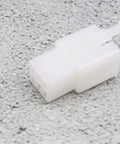 Close-up of a white plastic connector from E-Bike Hub Motor Nuts And Safety Washers Set For 750W To 1500W Motors With 14mm Shaft