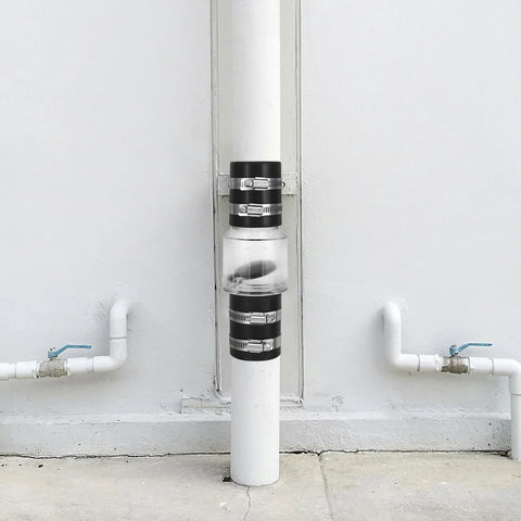 QWORK CV-150 silent check valve, 1-1/2 in, clear body with steel clamps, installed on PVC riser.