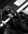 Close-up of 48DP Metal Pinion Gear Set for 1/18 RC Cars, 2.3mm shaft, installed on Traxxas LaTrax model, showing gear teeth and steel finish.