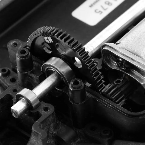 Close-up of 48DP Metal Pinion Gear Set for 1/18 RC Cars, 2.3mm shaft, installed on Traxxas LaTrax model, showing gear teeth and steel finish.