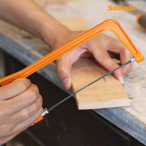 Cutting wood with hacksaw from 182 Piece Home Repair Tool Set With Durable Case For DIY Projects Must Have Dorm Essentials And Home Maintenance