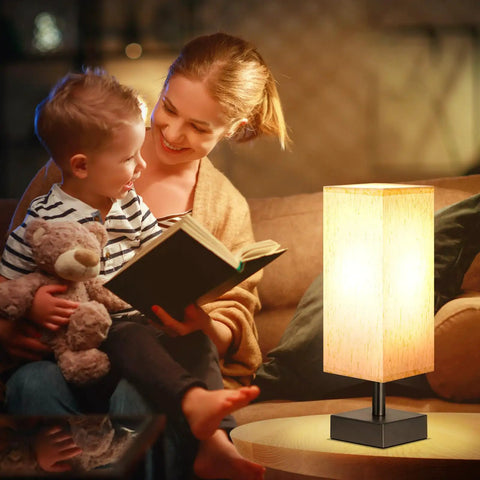 Small Table Lamp For Bedroom And Nightstand With Square Fabric Shade next to mother reading to child on couch