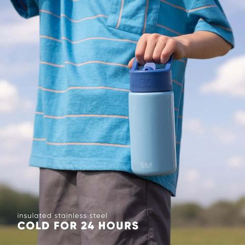 Child holding Disney Princess 14oz Kids Water Bottle With Straw Lid Insulated Stainless Steel Tumbler in blue, outdoors.