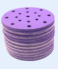 Get Ready To Polish Like A Pro With This Awesome 100 Piece 6 Inch Wet Dry Hook And Loop Sanding Discs Assortment Featuring 320 Grit Plus Many More For Wood Drywall And Metal Projects That Suck Less. Stack of purple 6-inch sanding discs with holes for dust extraction.