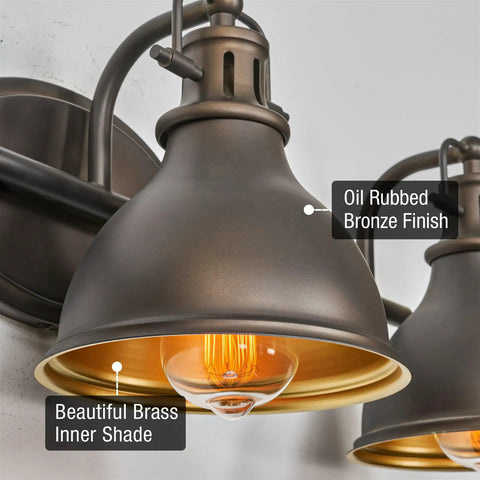 Close-up of Beacon 27 Inch Three Light Industrial Vanity Light With Brass Interior Shades Modern Farmhouse Wall Sconce in Oil Rubbed Bronze Finish.