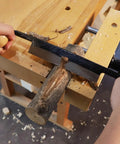 Straight Draw Knife Woodworking Shaving Tool Featuring Heavy Duty Steel Blade And Grippy Wooden Handle For No Sweat Bark Stripping Log Peeling And Quick Finishing Work used on a log with visible shavings.