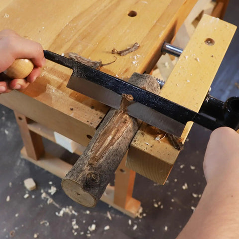 Straight Draw Knife Woodworking Shaving Tool Featuring Heavy Duty Steel Blade And Grippy Wooden Handle For No Sweat Bark Stripping Log Peeling And Quick Finishing Work used on a log with visible shavings.