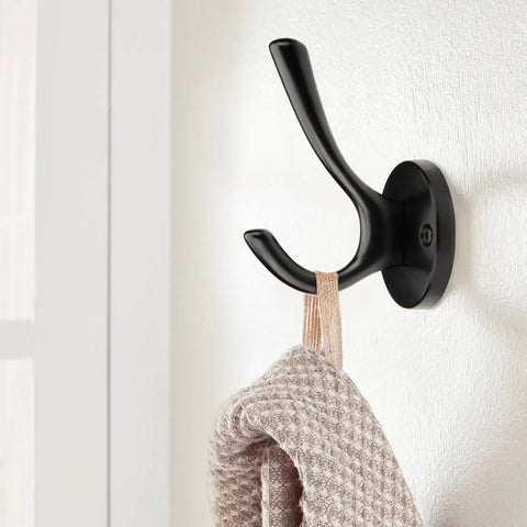 Matte black wall-mounted zinc alloy hook holding a towel, part of 5 Pack Round Coat And Towel Hooks Matte Black Wall Mounted Zinc Alloy Heavy Duty Hangers