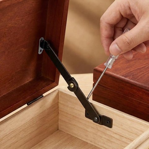 Installing Two Pack Bronze Lid Support Hinges For Jewelry Boxes And Small Chests Antique Folding Lid Stays on a wooden box with screwdriver.