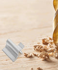 Close-up of Partition Buckle Shelf Clips for Cabinet Installation Support next to wood shavings and drill bit.